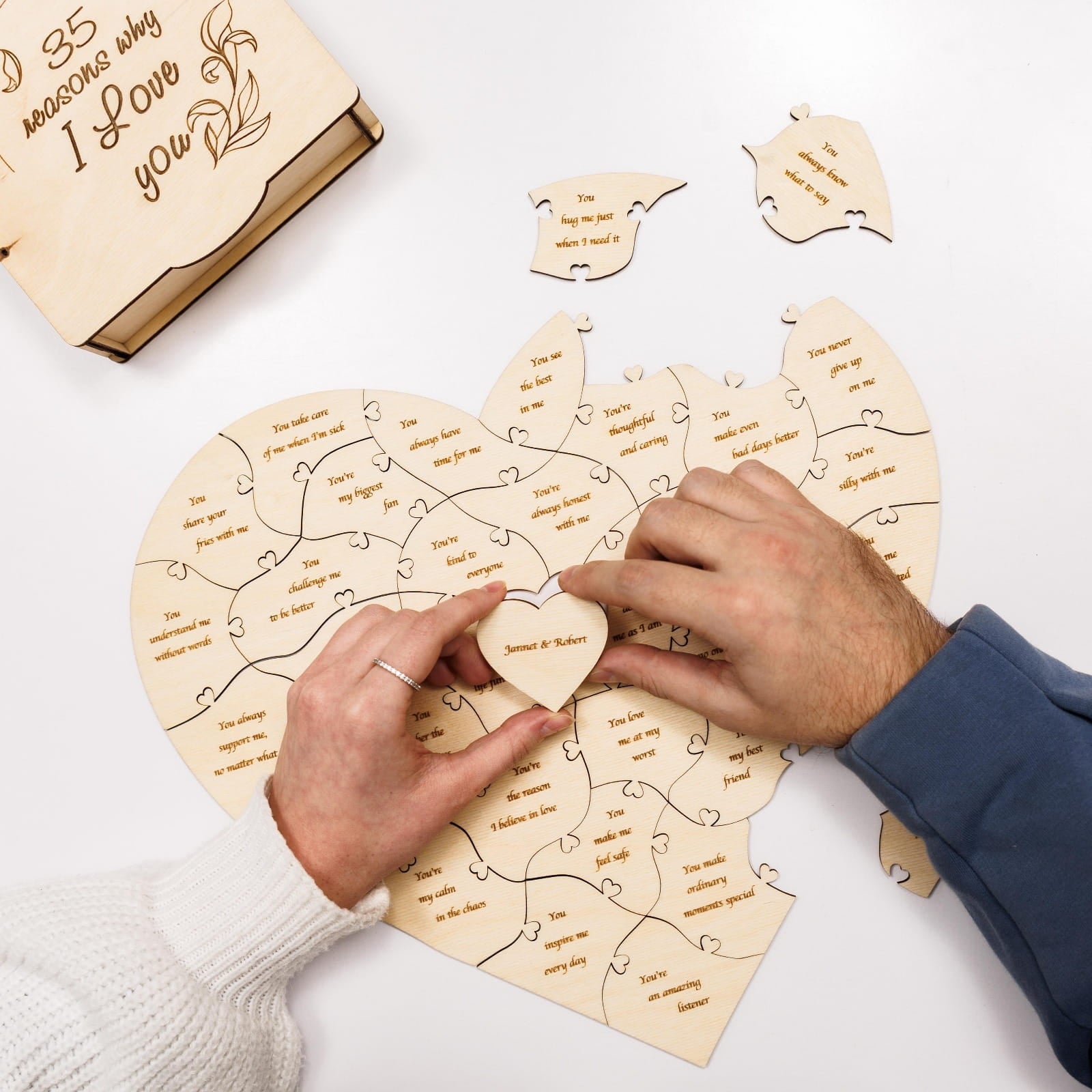 Heart-shaped wooden puzzle with '35 reasons why I love you' on a white background