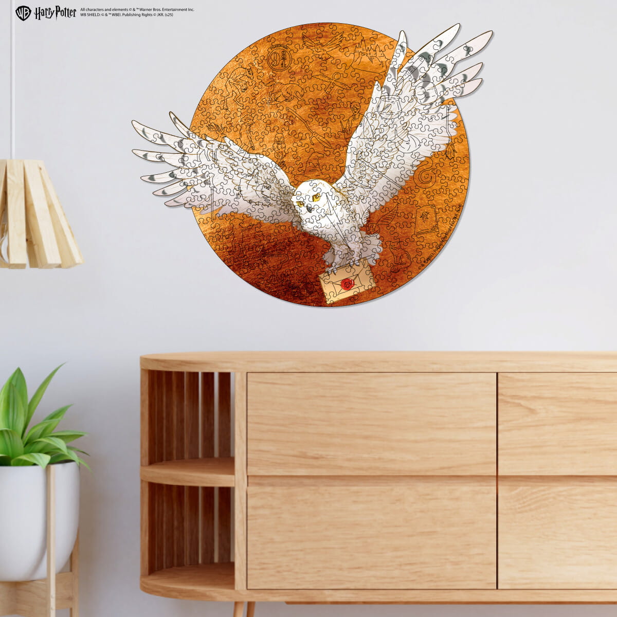 Decorative wall art of an owl on a circular map above a wooden cabinet.