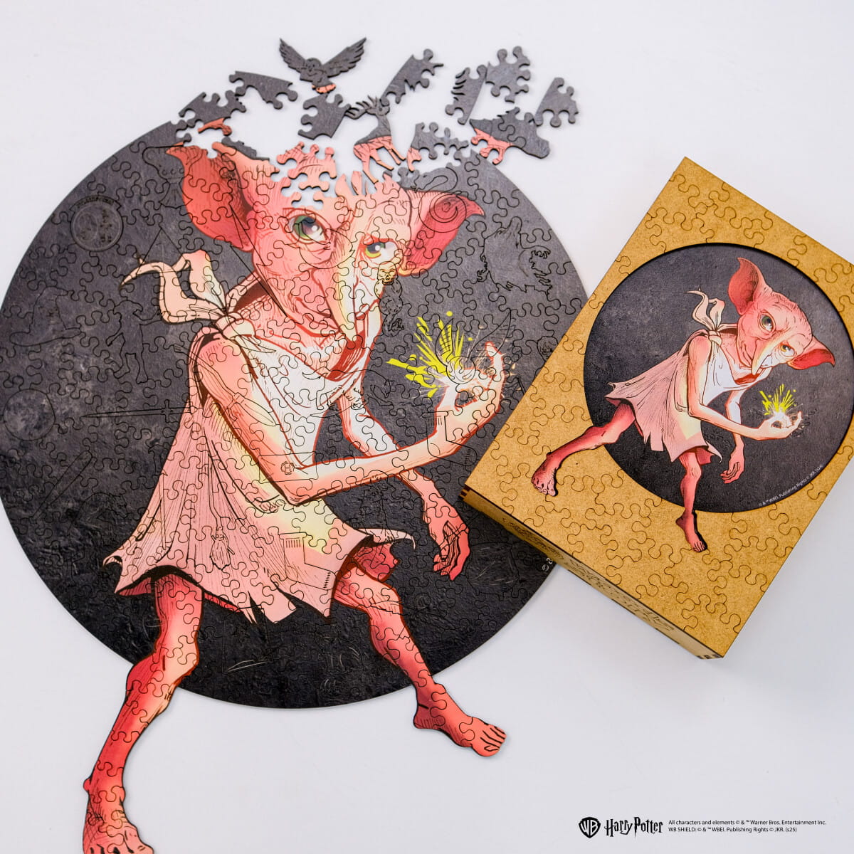 Jigsaw puzzle of a creature with a completed puzzle and box on a white background