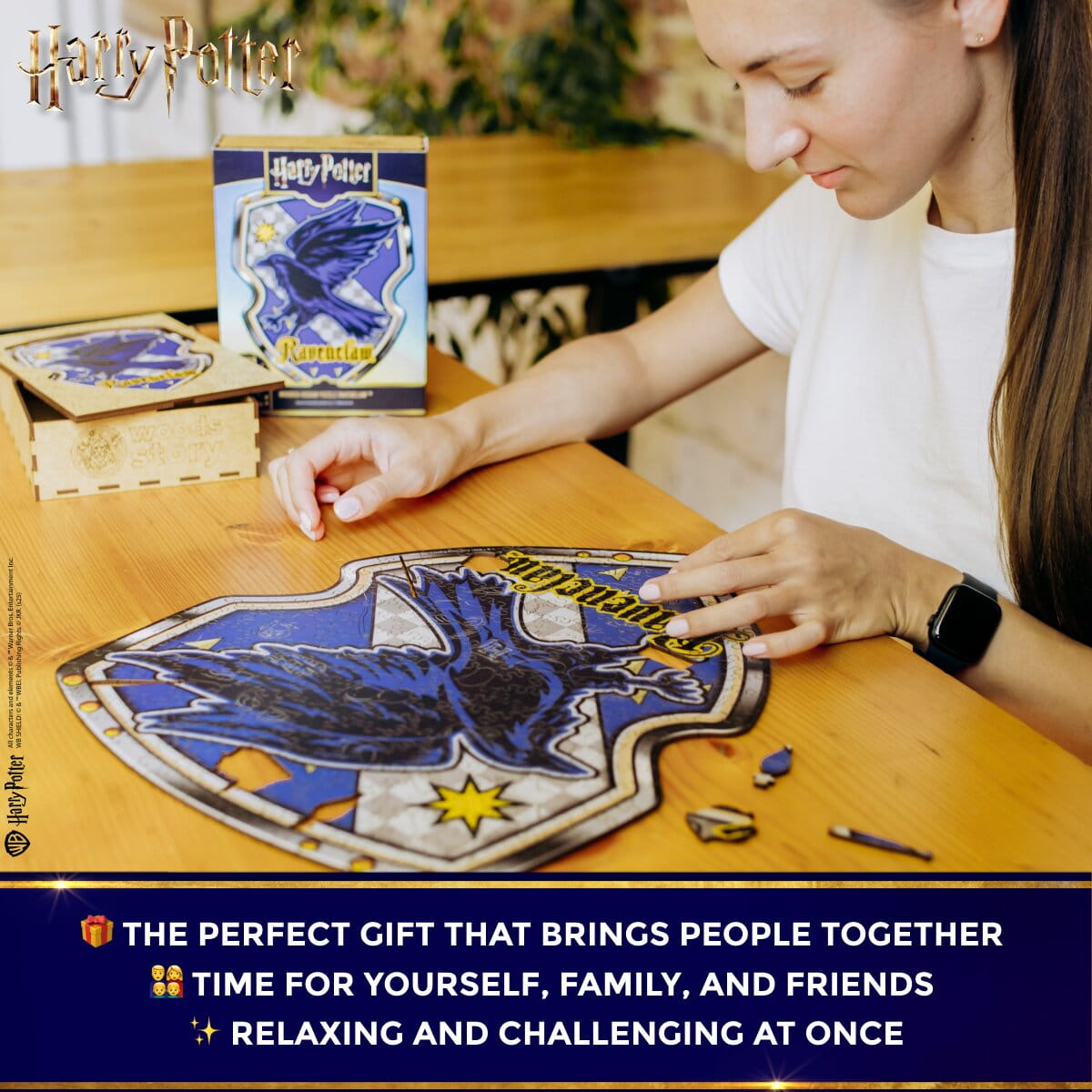 Person working on a puzzle with a Harry Potter theme, featuring the Hogwarts crest.