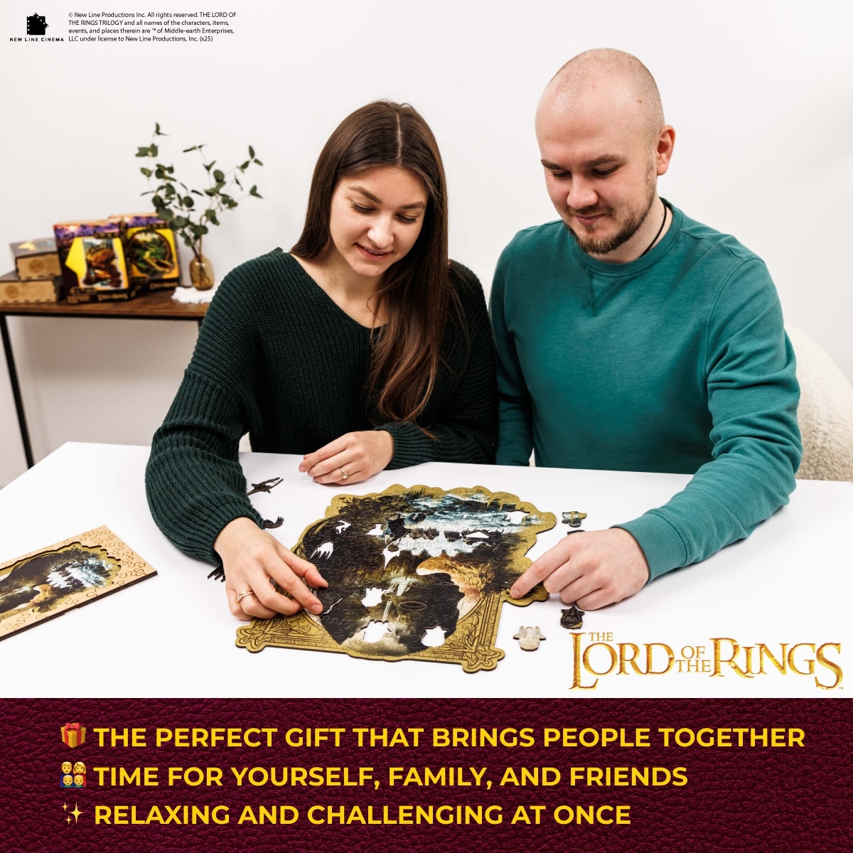 Two people working on a puzzle together with 'The Lord of the Rings' branding.
