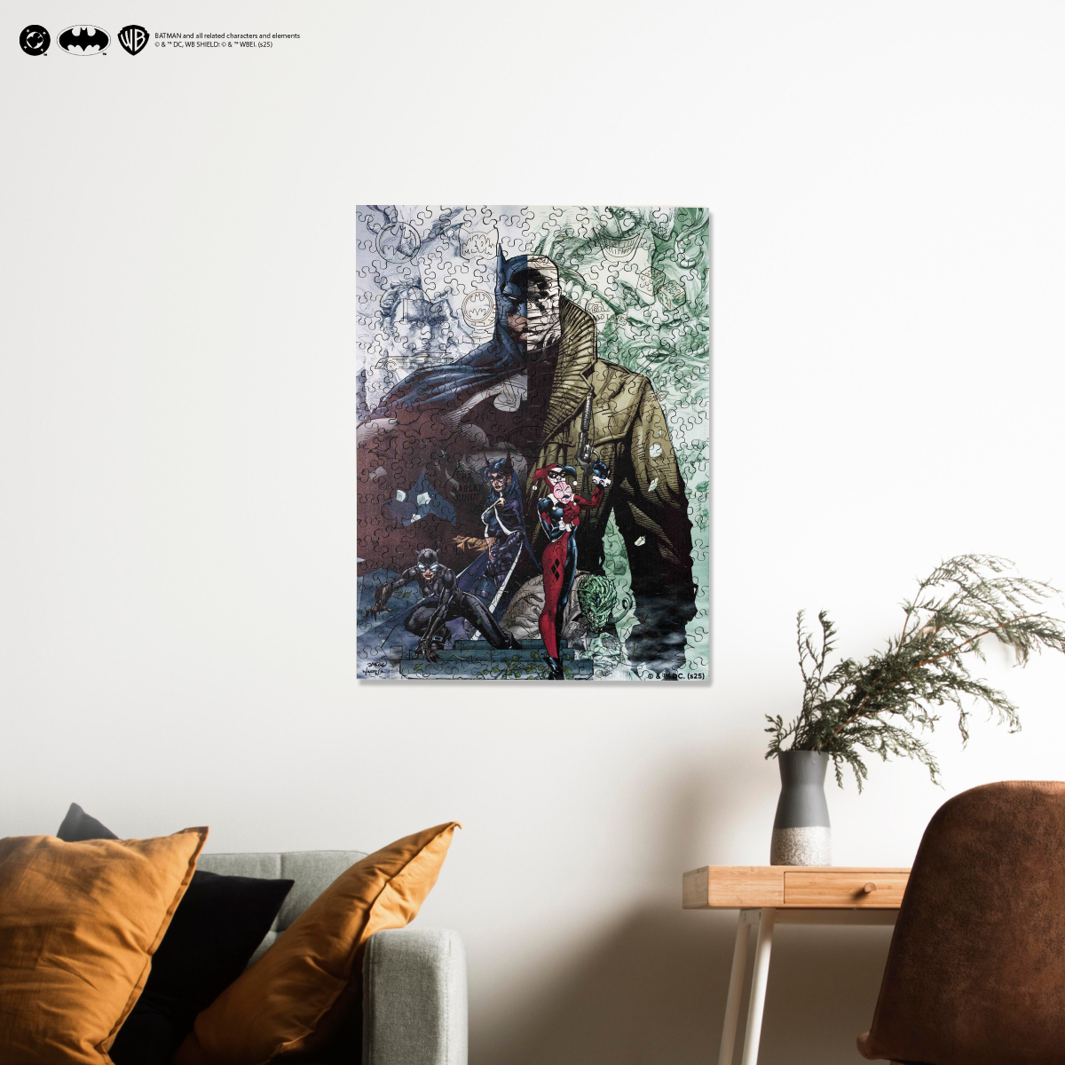 Batman artwork on a wall above a sofa with decorative pillows and a plant.