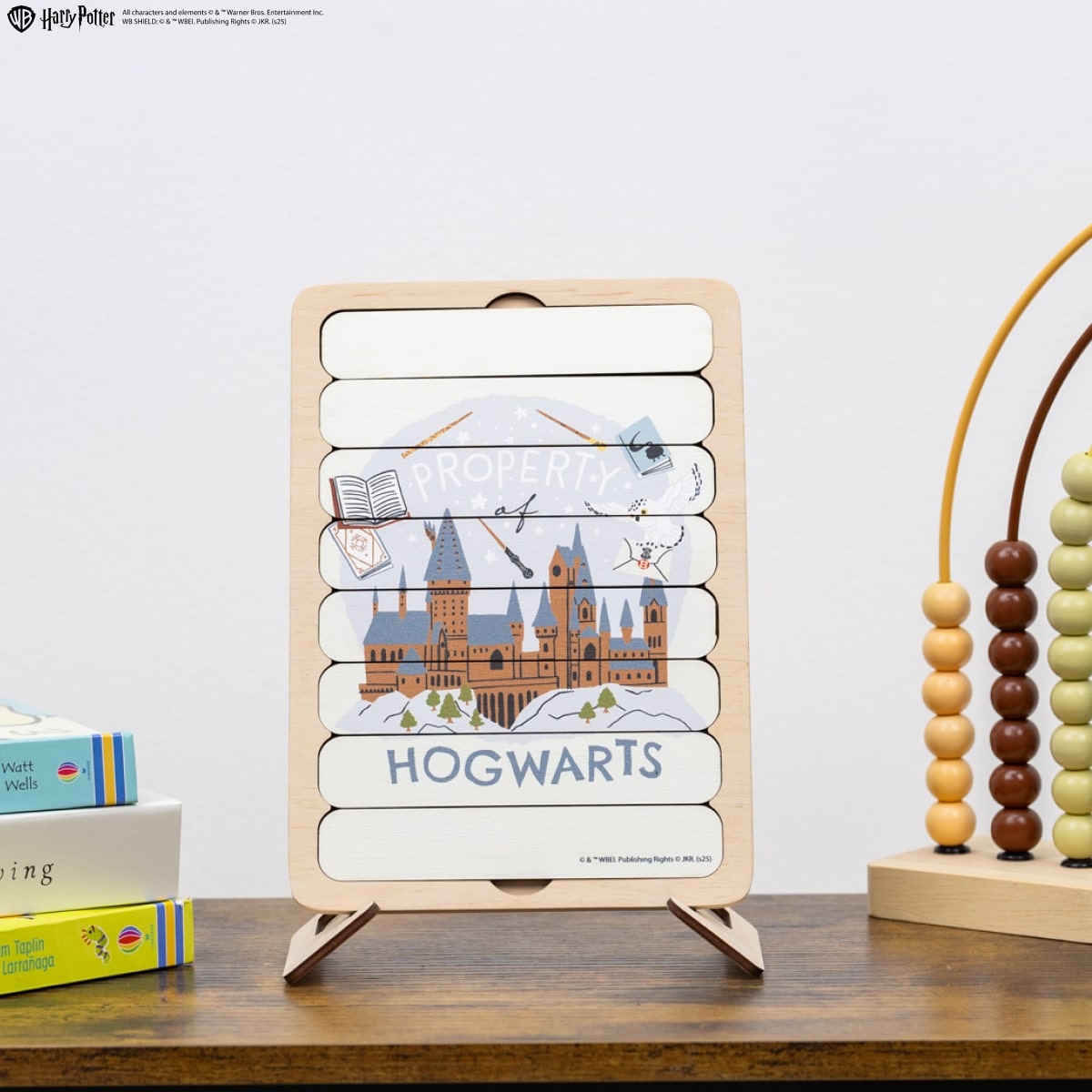 Wooden educational toy with 'Hogwarts' design on a wooden surface