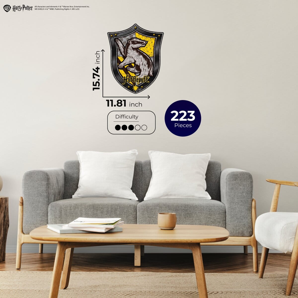 Living room with a gray sofa, wooden coffee table, and Hufflepuff house crest wall decal.